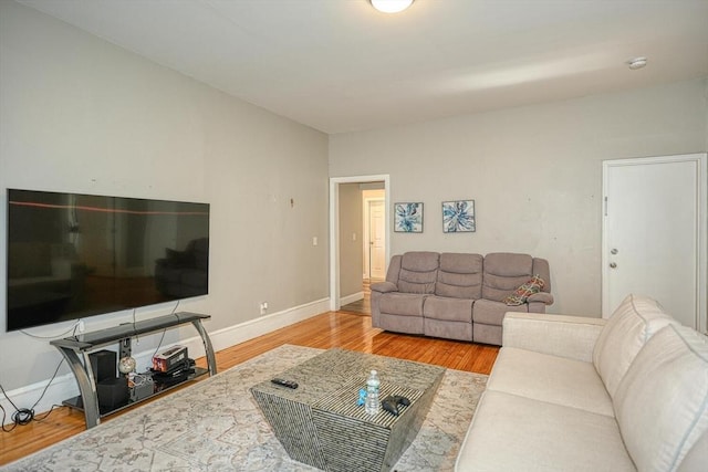 living room featuring wood finished floors and baseboards