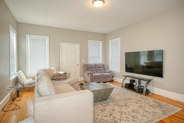 living area featuring baseboards and wood finished floors