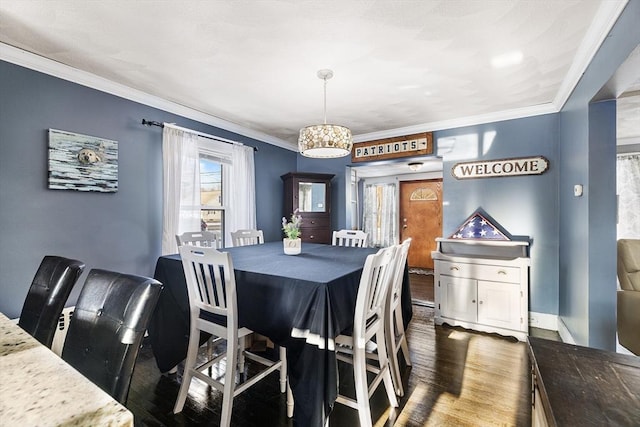 dining room featuring ornamental molding and dark hardwood / wood-style floors