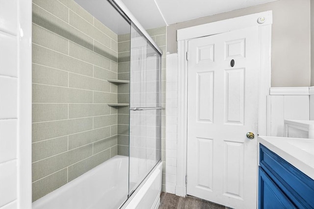 bathroom featuring tiled shower / bath, vanity, and hardwood / wood-style floors