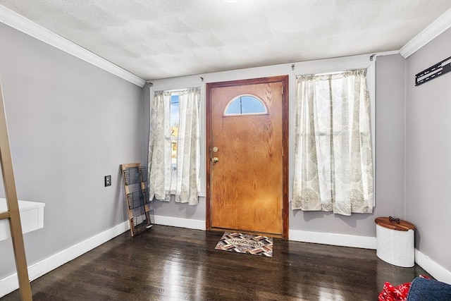 foyer with dark hardwood / wood-style flooring, crown molding, and a textured ceiling