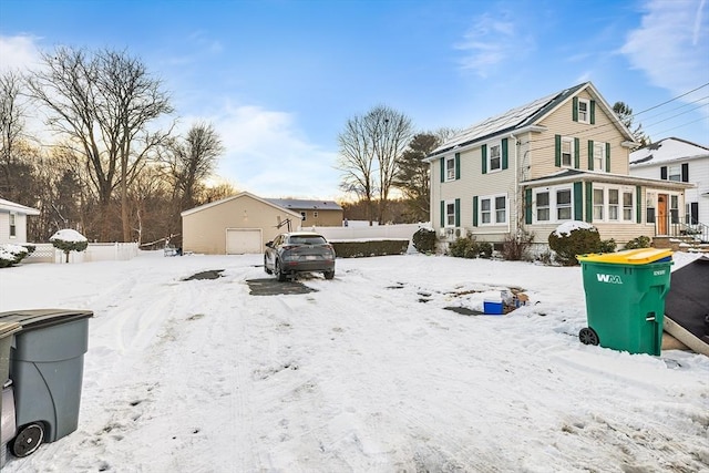 exterior space featuring a garage and an outbuilding