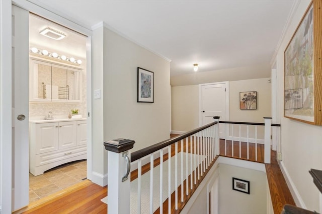 25 Piety Corner Rd, Waltham, MA 02451 - hallway with an upstairs landing, light wood finished floors, and a sink