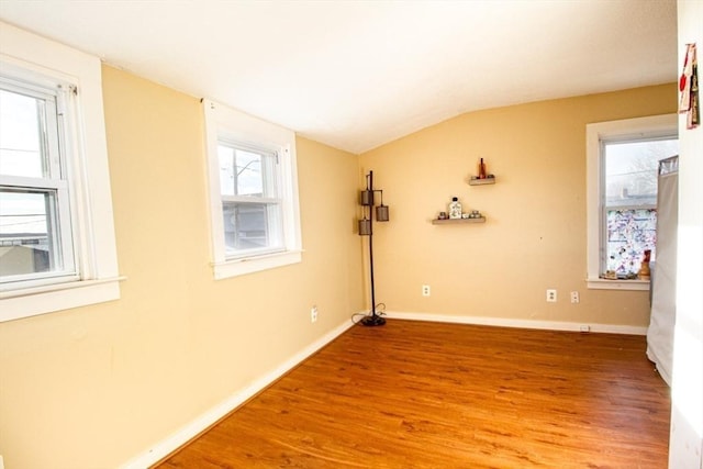 empty room featuring hardwood / wood-style floors and lofted ceiling