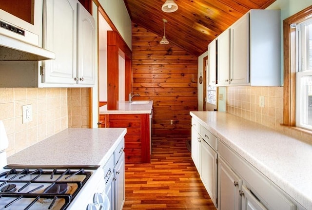 kitchen with stove, light hardwood / wood-style flooring, wooden ceiling, white cabinetry, and lofted ceiling