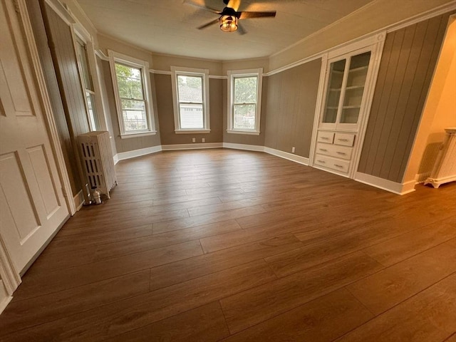 19 Chapel St, Shirley, MA 01464 - empty room with ceiling fan, dark wood-style flooring, plenty of natural light, radiator heating unit, and ornamental molding