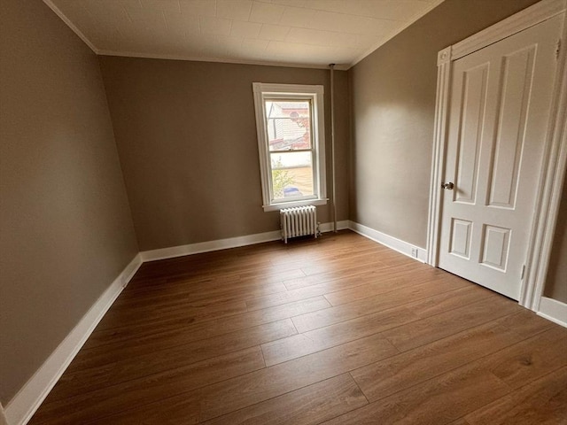 19 Chapel St, Shirley, MA 01464 - empty room with ornamental molding, radiator, and wood finished floors
