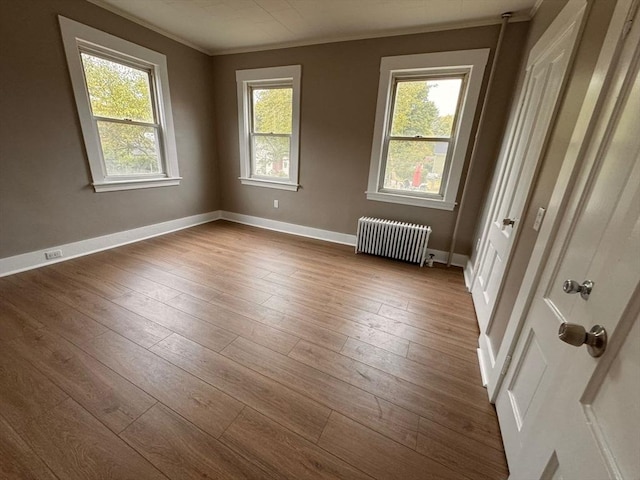 19 Chapel St, Shirley, MA 01464 - unfurnished room with radiator heating unit, dark wood-style flooring, and ornamental molding