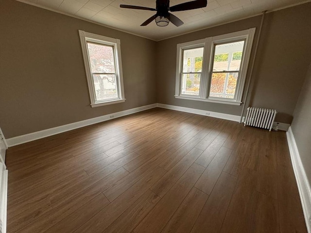 19 Chapel St, Shirley, MA 01464 - unfurnished room with ceiling fan, plenty of natural light, radiator, and dark wood-style flooring