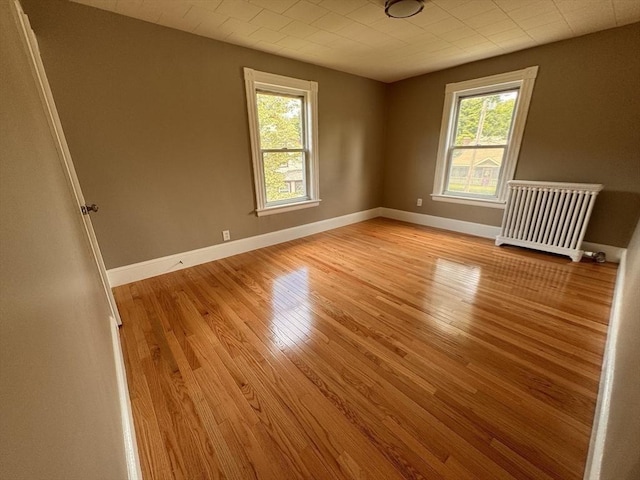 19 Chapel St, Shirley, MA 01464 - unfurnished room featuring light wood-type flooring and radiator