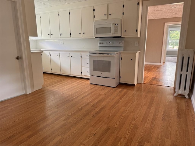 19 Chapel St, Shirley, MA 01464 - kitchen featuring white appliances, light countertops, white cabinetry, and light wood finished floors