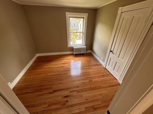 19 Chapel St, Shirley, MA 01464 - empty room featuring radiator, ornamental molding, and light wood finished floors