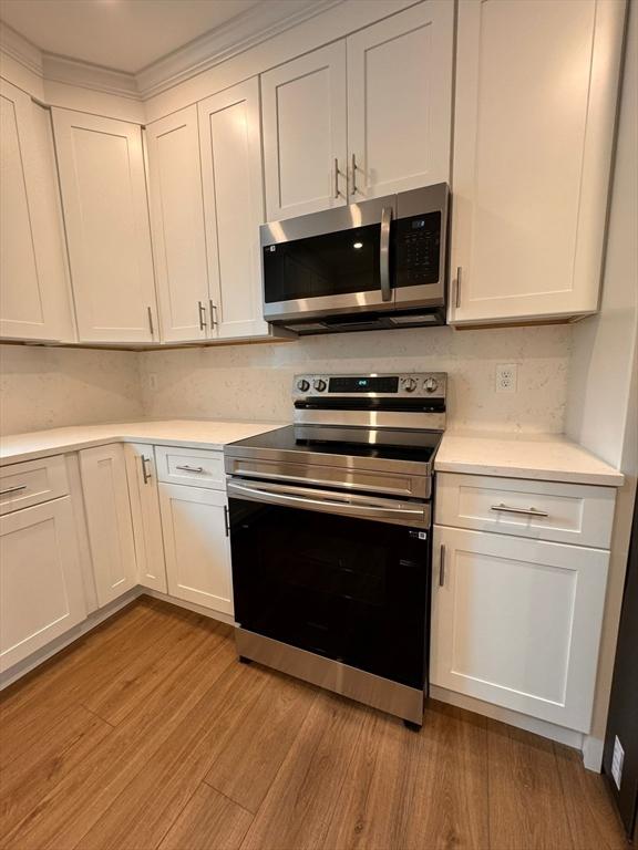 19 Chapel St, Shirley, MA 01464 - kitchen featuring stainless steel appliances, light wood-type flooring, and light countertops