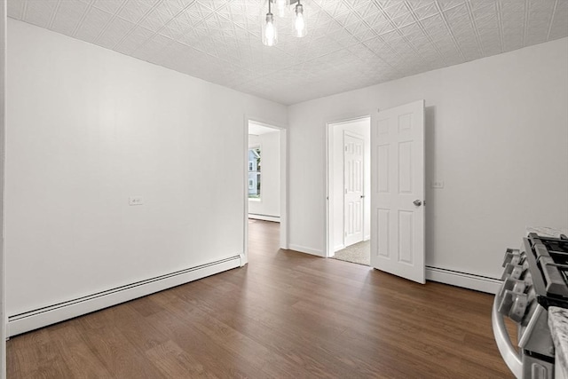50 Howard St, Haverhill, MA 01830 - empty room featuring a baseboard radiator, a baseboard heating unit, and wood finished floors