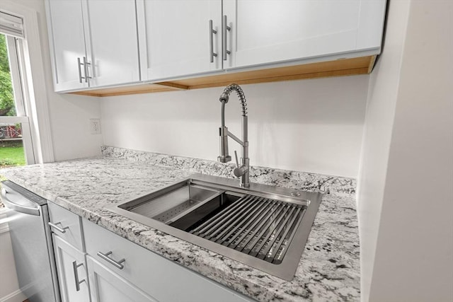 50 Howard St, Haverhill, MA 01830 - kitchen view of white cabinets, dishwasher, and light stone counters