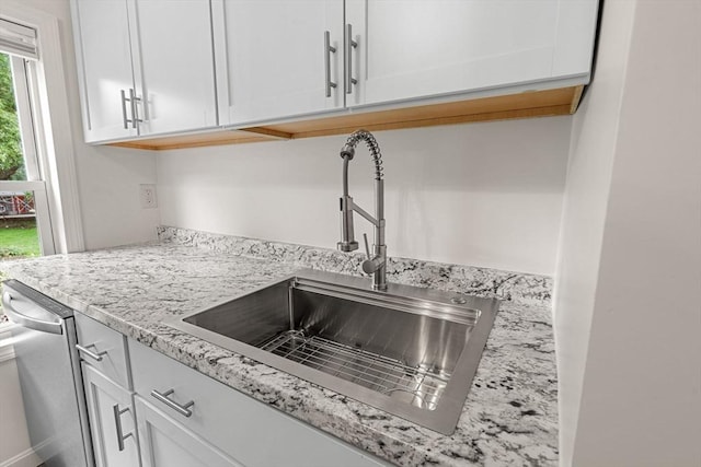 50 Howard St, Haverhill, MA 01830 - kitchen view of white cabinets, stainless steel dishwasher, and light stone counters