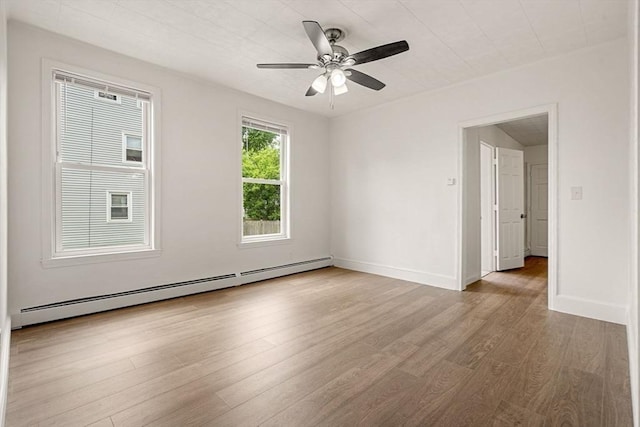 50 Howard St, Haverhill, MA 01830 - unfurnished room featuring a baseboard radiator, wood finished floors, and ceiling fan