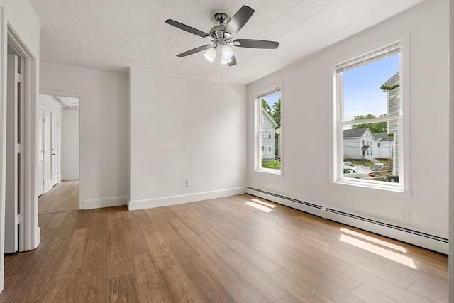 50 Howard St, Haverhill, MA 01830 - unfurnished room with a baseboard heating unit, wood finished floors, and a ceiling fan