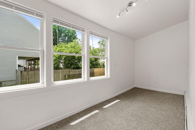 50 Howard St, Haverhill, MA 01830 - empty room with carpet floors, rail lighting, and a baseboard heating unit
