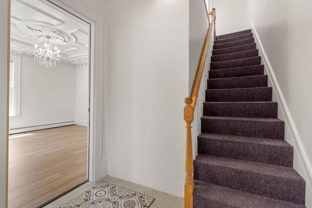 50 Howard St, Haverhill, MA 01830 - stairway with baseboard heating, a chandelier, and tile patterned floors