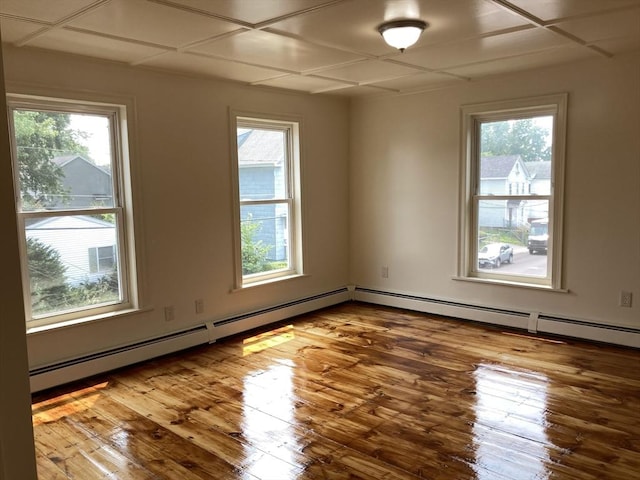 50 Howard St, Haverhill, MA 01830 - spare room with wood finished floors and a baseboard heating unit