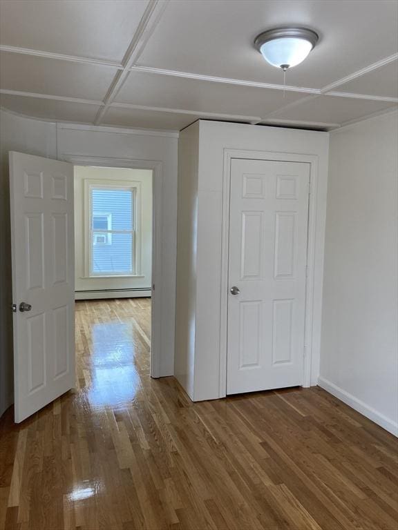 50 Howard St, Haverhill, MA 01830 - corridor with wood finished floors and baseboard heating