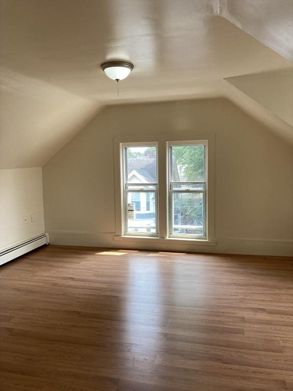 50 Howard St, Haverhill, MA 01830 - additional living space with wood finished floors, vaulted ceiling, and a baseboard heating unit