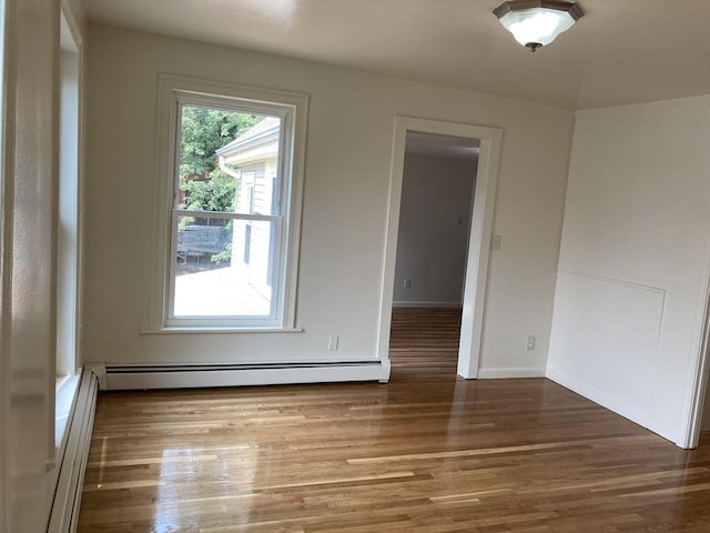 50 Howard St, Haverhill, MA 01830 - empty room featuring a baseboard heating unit and wood finished floors