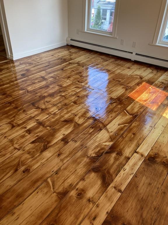 50 Howard St, Haverhill, MA 01830 - detailed view of wood finished floors and a baseboard heating unit