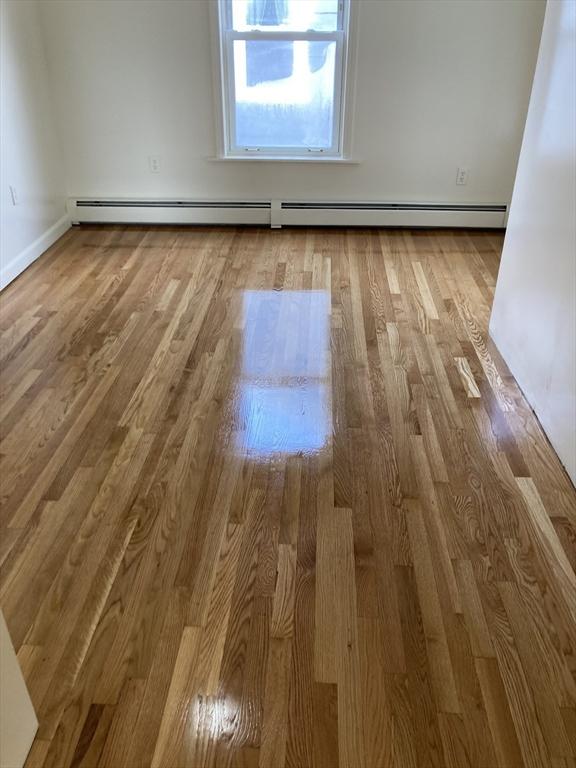 50 Howard St, Haverhill, MA 01830 - unfurnished room with a baseboard radiator and wood finished floors