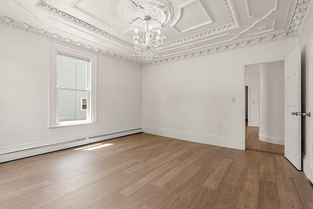 50 Howard St, Haverhill, MA 01830 - spare room with a chandelier, wood finished floors, a baseboard radiator, and a raised ceiling