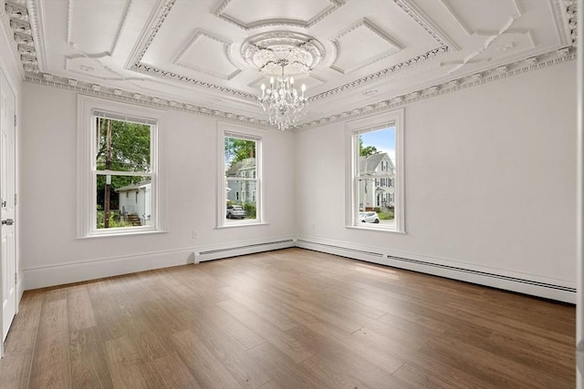 50 Howard St, Haverhill, MA 01830 - spare room featuring a chandelier, wood finished floors, baseboard heating, and crown molding