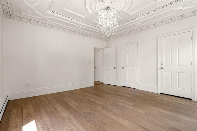 50 Howard St, Haverhill, MA 01830 - empty room featuring a chandelier, wood finished floors, a baseboard radiator, and a raised ceiling