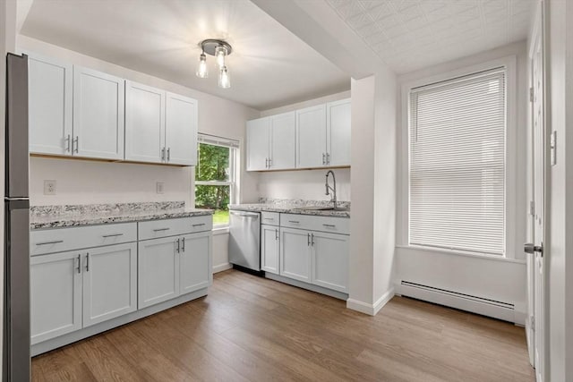 50 Howard St, Haverhill, MA 01830 - kitchen featuring stainless steel dishwasher, baseboard heating, light wood-style floors, light stone countertops, and white cabinets