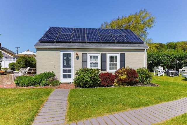 164 Kendrick Ave Unit 2 & 3, Wellfleet, MA 02667 - view of front facade with solar panels, a front lawn, and a patio