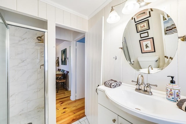 164 Kendrick Ave Unit 2 & 3, Wellfleet, MA 02667 - full bath with a stall shower, toilet, vanity, ornamental molding, and wood finished floors