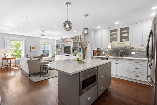 256 W Newton St Unit 1, Boston, MA 02116 - kitchen featuring stainless steel appliances, a sink, light countertops, white cabinetry, and dark wood-style floors