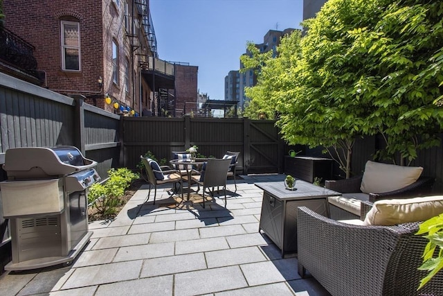 256 W Newton St Unit 1, Boston, MA 02116 - fenced backyard featuring a gate, outdoor dining area, a patio area, area for grilling, and an outdoor living space