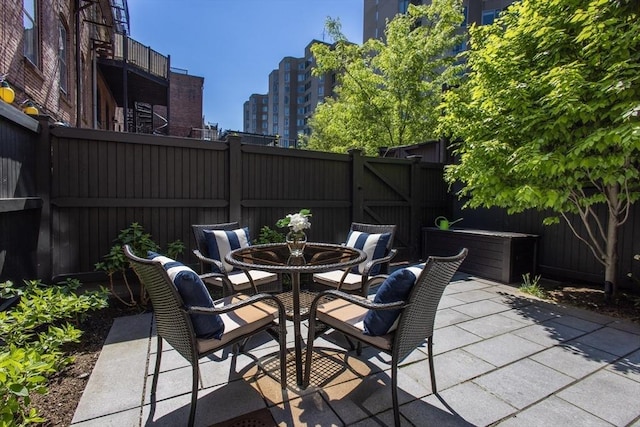 256 W Newton St Unit 1, Boston, MA 02116 - fenced backyard with a patio area, outdoor dining space, and a city view
