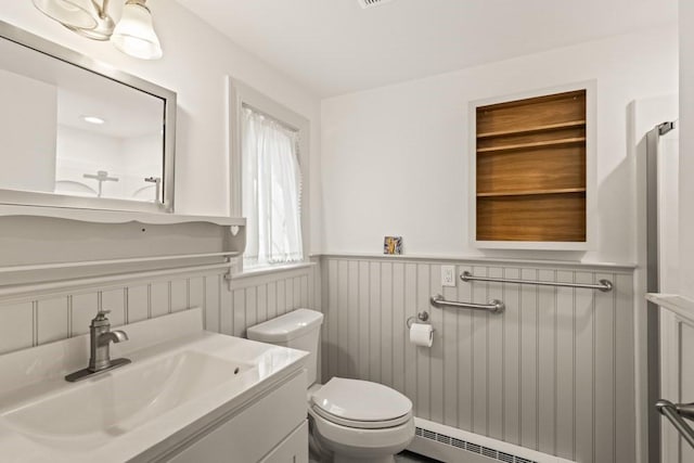 56 Fairwood Rd, Yarmouth, MA 02664 - bathroom with vanity, a baseboard radiator, toilet, and a wainscoted wall