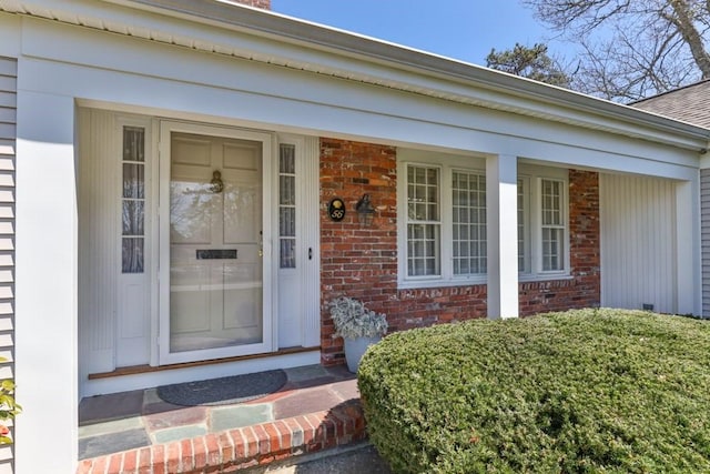56 Fairwood Rd, Yarmouth, MA 02664 - doorway to property featuring covered porch and brick siding