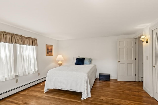 56 Fairwood Rd, Yarmouth, MA 02664 - bedroom with a baseboard heating unit, wood finished floors, and a baseboard radiator