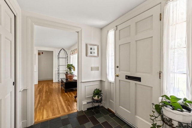 56 Fairwood Rd, Yarmouth, MA 02664 - entrance foyer with baseboard heating and dark wood-style flooring