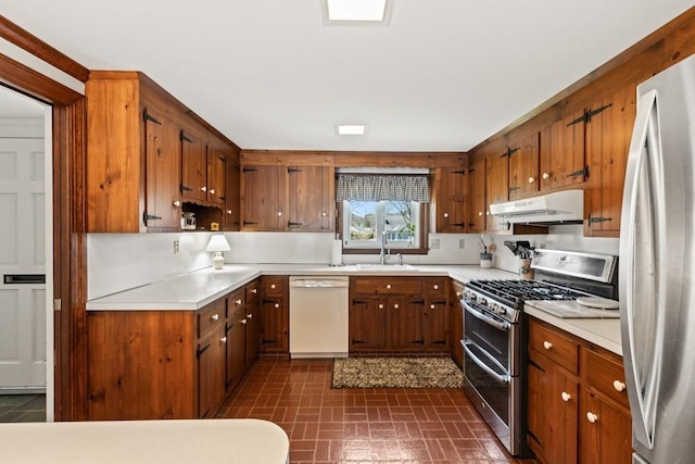 56 Fairwood Rd, Yarmouth, MA 02664 - kitchen featuring a sink, brown cabinetry, stainless steel appliances, light countertops, and under cabinet range hood