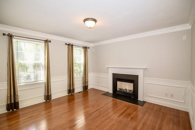 12 Kestrel Ln Unit 7, Westford, MA 01886 - unfurnished living room featuring wood finished floors, a fireplace with flush hearth, ornamental molding, and wainscoting