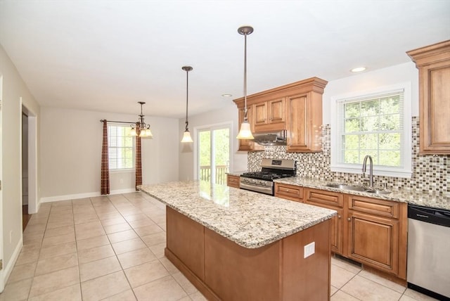 12 Kestrel Ln Unit 7, Westford, MA 01886 - kitchen with appliances with stainless steel finishes, a sink, a center island, backsplash, and light tile patterned flooring
