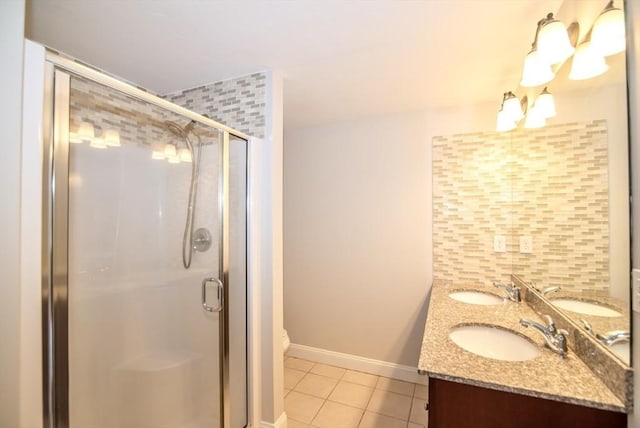 12 Kestrel Ln Unit 7, Westford, MA 01886 - bathroom with tile patterned flooring, a shower stall, baseboards, and double vanity