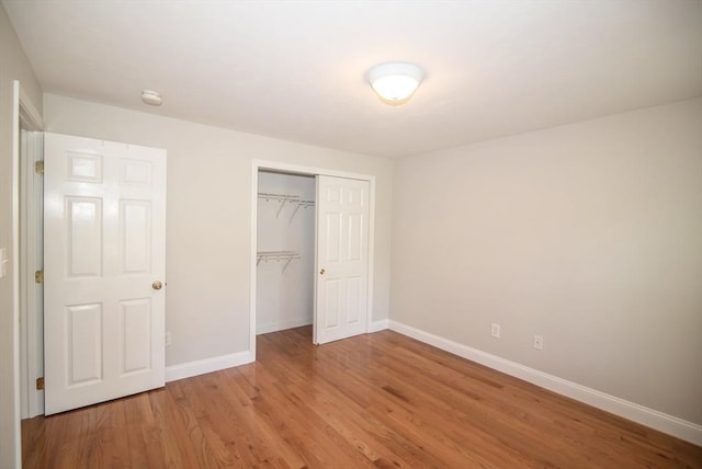 12 Kestrel Ln Unit 7, Westford, MA 01886 - unfurnished bedroom with baseboards, a closet, and light wood finished floors
