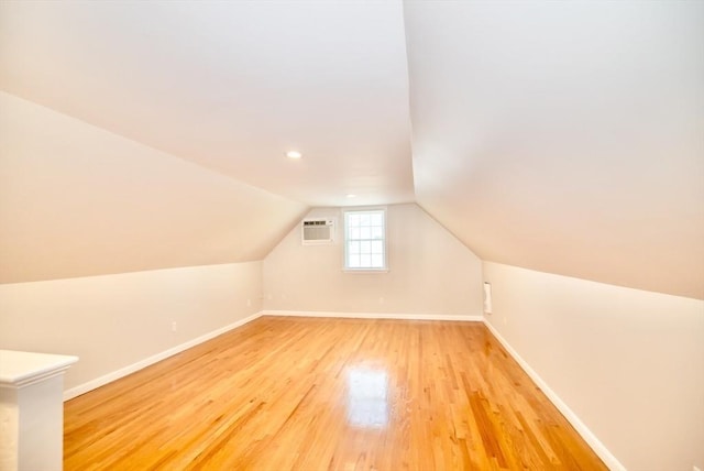 12 Kestrel Ln Unit 7, Westford, MA 01886 - additional living space with light wood-style floors, baseboards, a wall unit AC, and vaulted ceiling