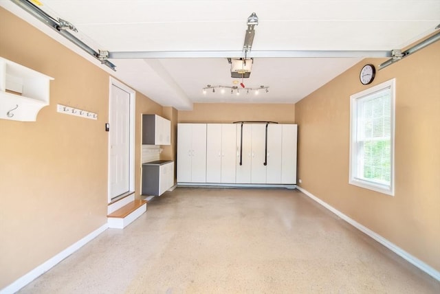 12 Kestrel Ln Unit 7, Westford, MA 01886 - garage with baseboards and a garage door opener